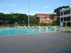 The right side of the swimming pool, a few bikini-clad ladies in the background
